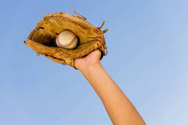 arm reaching high and catching baseball